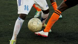 legs kicking a football